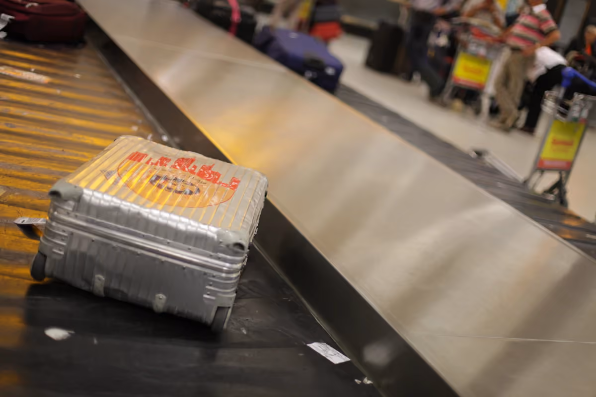 Gray suitcase on an airport baggage carousel