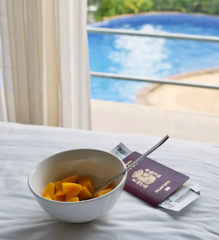 Breakfast and travel documents beside a hotel window