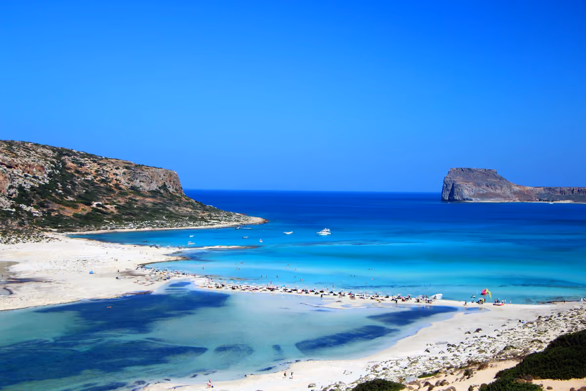 Turquoise shallows and rocky coastline at Balos Beach in Crete