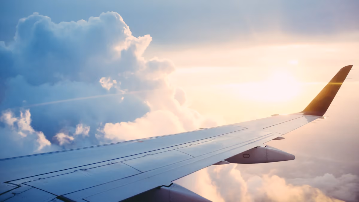 An airplane wing above clouds during a flight