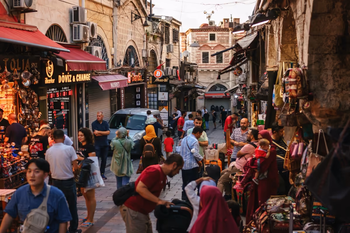 Shoppers walking along a busy market street in Istanbul