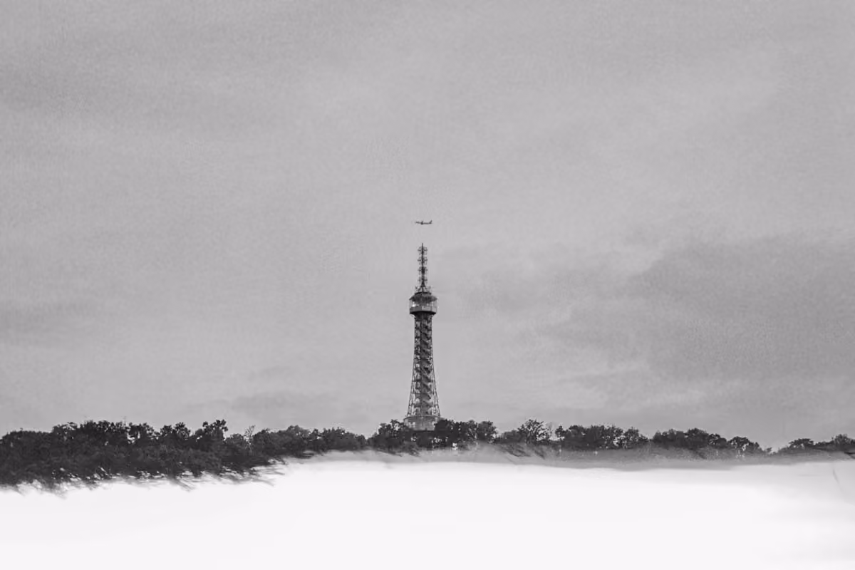Petřín Lookout Tower above misty trees in Prague