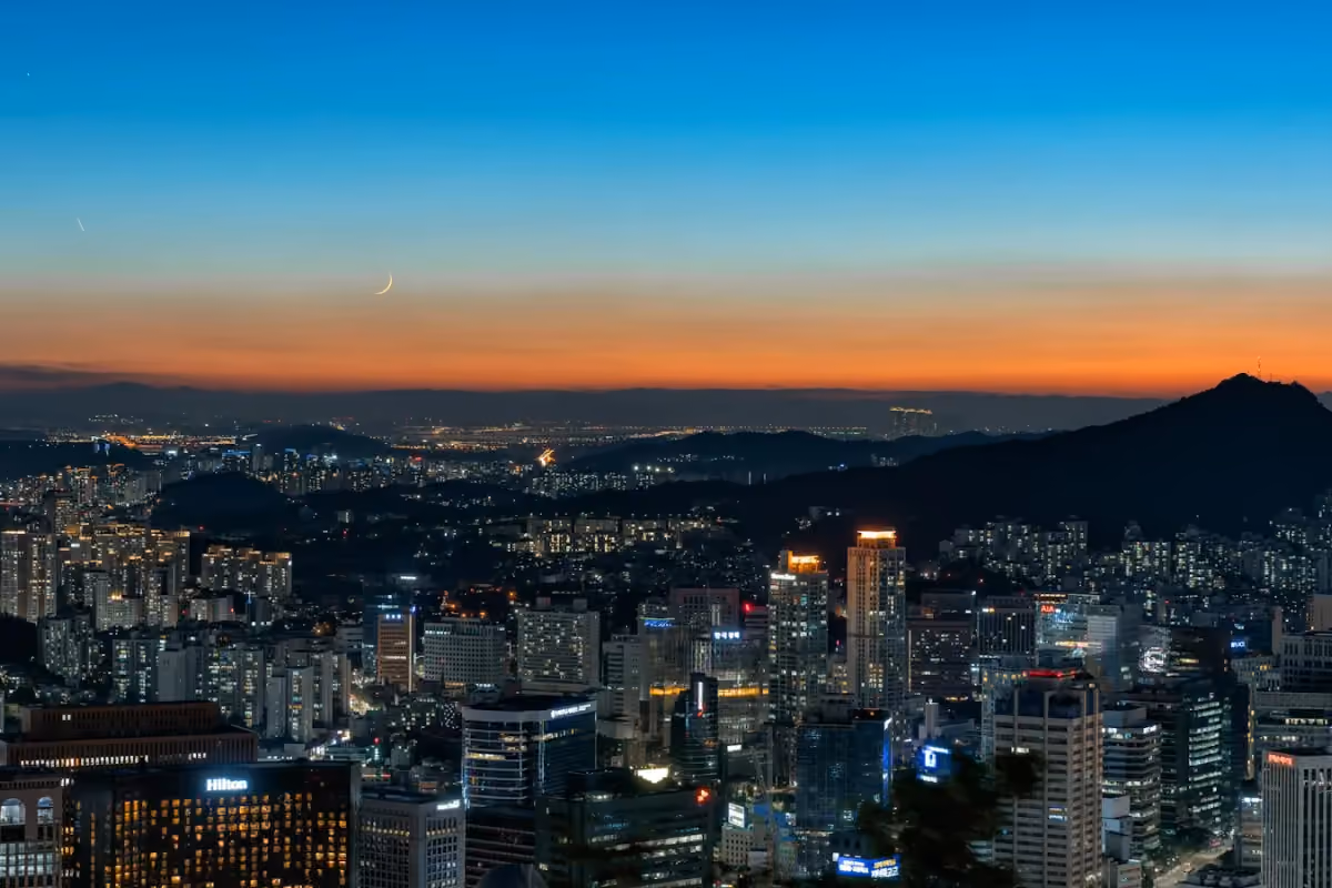 The illuminated Seoul skyline seen from Namsan at dusk