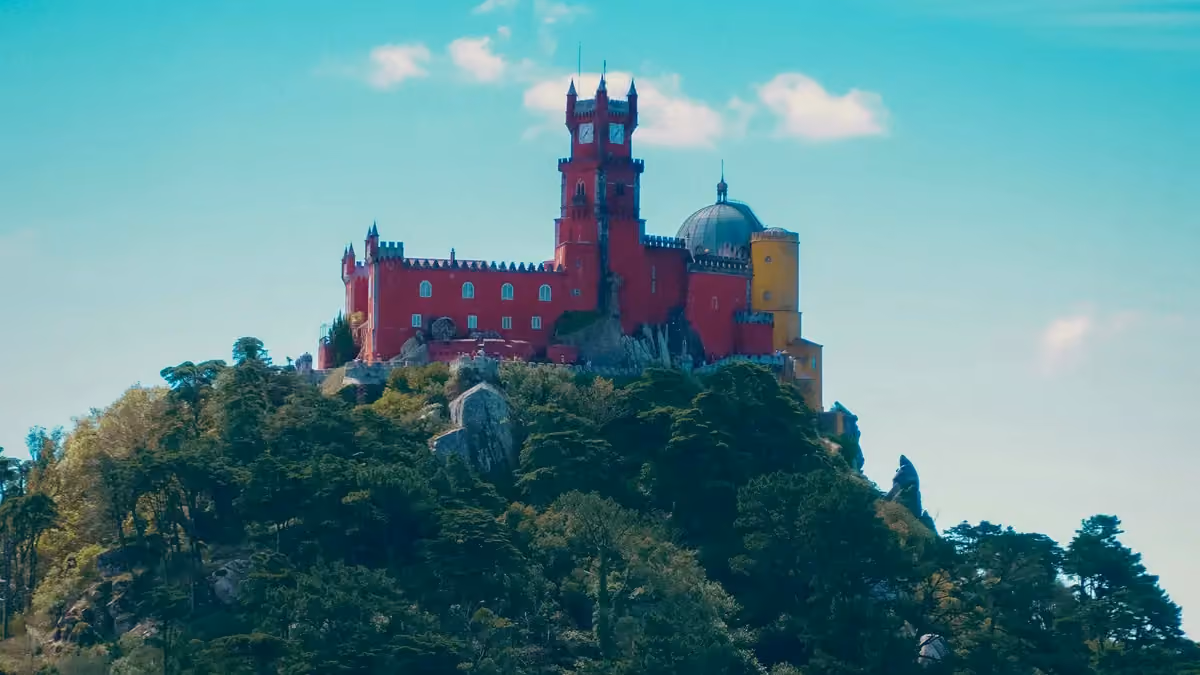 The colorful Pena Palace above the wooded hills of Sintra, Portugal