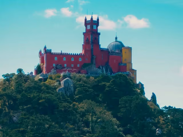 The colorful Pena Palace above the wooded hills of Sintra, Portugal