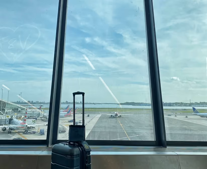 A suitcase beside a terminal window in Newark