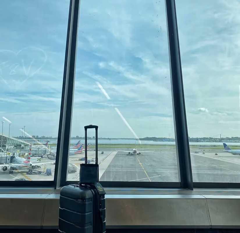 A suitcase beside a terminal window in Newark